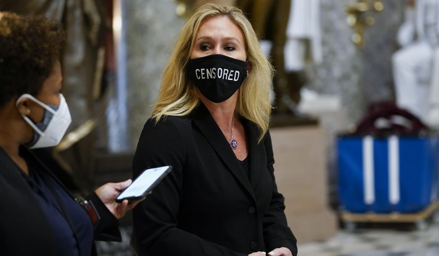 Rep. Marjorie Taylor Greene, R-Ga., walks on Capitol Hill in Washington, Wednesday, Jan. 13, 2021. (AP Photo/Susan Walsh)