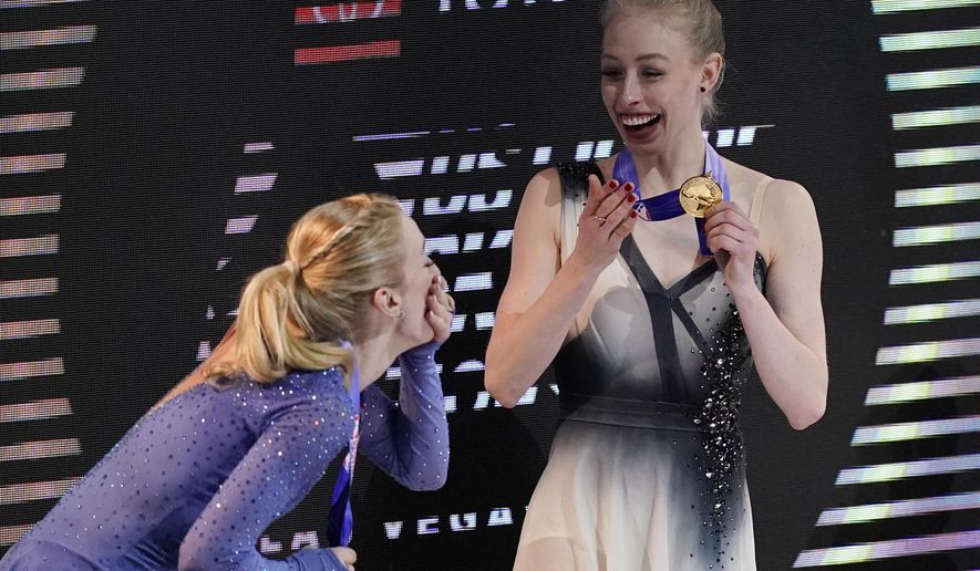 Second-place Amber Glenn, left, and first-place Bradie Tennell smile after receiving their medals at the U.S. Figure Skating Championships, Friday, Jan. 15, 2021, in Las Vegas. (AP Photo/John Locher)