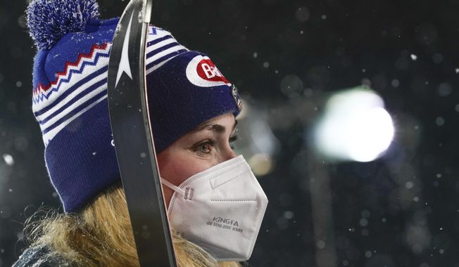 United States&#x27; Mikaela Shiffrin wears a face mask as she waits for the podium ceremony after winning an alpine ski, women&#x27;s World Cup slalom in Flachau, Austria, Tuesday, Jan. 12, 2021. (AP Photo/Giovanni Auletta)