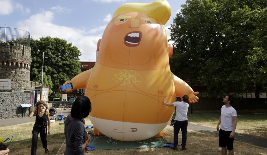 FILE - In this file photo taken Tuesday, July 10, 2018, a six-meter high cartoon baby blimp depicting U.S. President Donald Trump in north London. The President Trump blimp will become part of the Museum of London&#39;s protest collection exhibition, which includes artifacts from the women’s suffrage movement, peace activists who opposed the war in Iraq during the early 2000s, and more recent protests against public spending cuts, the museum has announced Monday Jan. 18, 2021.  (AP Photo/Matt Dunham, FILE)
