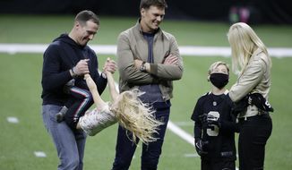 New Orleans Saints quarterback Drew Brees, left, plays with his children as Tampa Bay Buccaneers quarterback Tom Brady speaks with Brittany Brees after an NFL divisional round playoff football game between the New Orleans Saints and the Tampa Bay Buccaneers, Sunday, Jan. 17, 2021, in New Orleans. The Tampa Bay Buccaneers won 30-20. (AP Photo/Butch Dill)