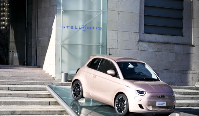 The new Stellantis logo was added on the side of the other logos of the group, on the day of the stock market debut, at the historic Mirafiori headquarters in Turin, Italy, Monday, Jan. 18, 2021. Stellantis, the car company combining PSA Peugeot and Fiat Chrysler, was launched Monday on the Milan and Paris stock exchanges, giving life to the fourth-largest car company in the world. (Marco Alpozzi/LaPresse via AP)