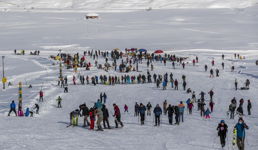 Indian tourists and locals ski on a slope in Gulmarg, northwest of Srinagar, Indian controlled Kashmir, Monday, Jan. 11, 2021. Snow this winter has brought along with it thousands of locals and tourists to Indian-controlled Kashmir&#x27;s high plateau, pastoral Gulmarg, which translates as “meadow of flowers.&amp;quot; (AP Photo/ Dar Yasin)
