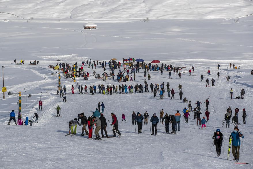 Indian tourists and locals ski on a slope in Gulmarg, northwest of Srinagar, Indian controlled Kashmir, Monday, Jan. 11, 2021. Snow this winter has brought along with it thousands of locals and tourists to Indian-controlled Kashmir's high plateau, pastoral Gulmarg, which translates as “meadow of flowers." (AP Photo/ Dar Yasin)