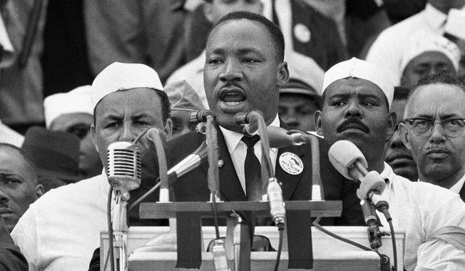 FILE - In this Aug. 28, 1963 file photo, Dr. Martin Luther King Jr., head of the Southern Christian Leadership Conference, addresses marchers during his &amp;quot;I Have a Dream&amp;quot; speech at the Lincoln Memorial in Washington. The annual celebration of the Martin Luther King Jr. holiday in his hometown in Atlanta is calling for renewed dedication to nonviolence following a turbulent year. The slain civil rights leader&#x27;s daughter, the Rev. Bernice King, said in an online church service Monday, Jan. 18, 2021, that physical violence and hateful speech are “out of control” in the aftermath of a divisive election followed by a deadly siege on the U.S. Capitol in Washington by supporters of President Donald Trump. (AP Photo/File)