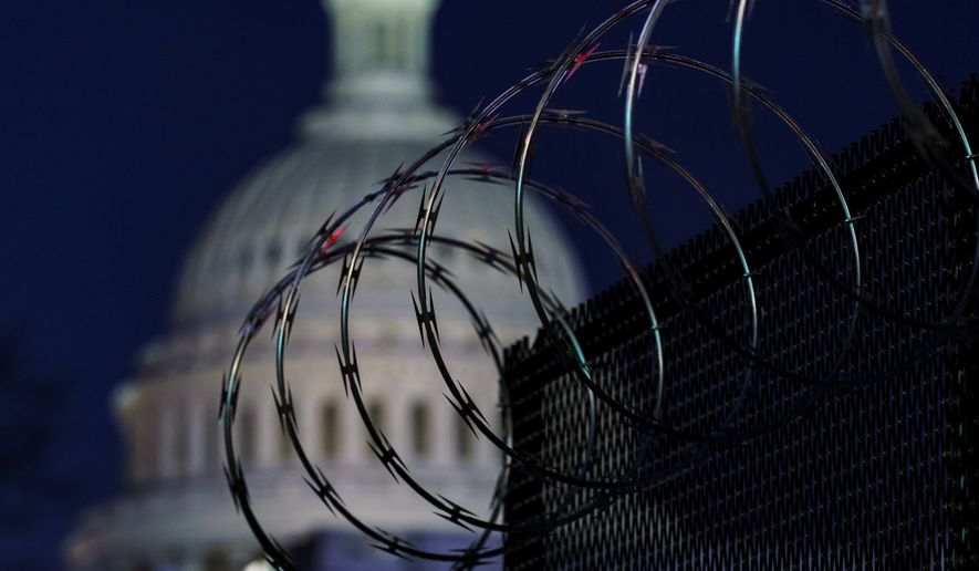 Riot fencing and razor wire reinforce the security zone on Capitol Hill in Washington, Tuesday, Jan. 19, 2021, before President-elect Joe Biden is sworn in as the 46th president on Wednesday. (AP Photo/J. Scott Applewhite)