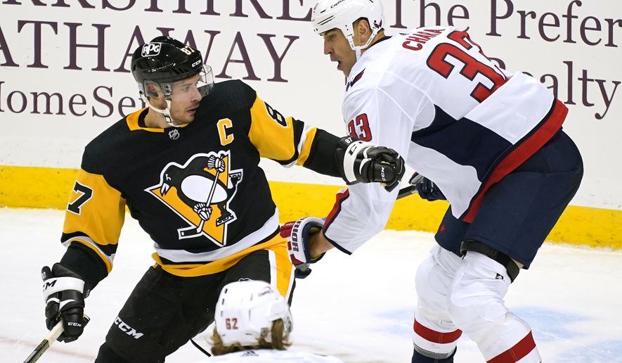 Pittsburgh Penguins&#39; Sidney Crosby (87) is defended by Washington Capitals&#39; Zdeno Chara (33) during the first period of an NHL hockey game in Pittsburgh, Tuesday, Jan. 19, 2021. (AP Photo/Gene J. Puskar)