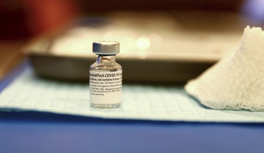 A vile of the Pfizer-BioNTech COVID-19 Vaccine, is shown, Tuesday, Jan. 19, 2021, at Atrium Medical Center in Middletown, Ohio. (Kareem Elgazzar /The Cincinnati Enquirer via AP)