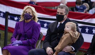 President-elect Joe Biden&#39;s wife Jill Biden sits with Hunter Biden and his child during an event at the Major Joseph R. &amp;quot;Beau&amp;quot; Biden III National Guard/Reserve Center, Tuesday, Jan. 19, 2021, in New Castle, Del. (AP Photo/Evan Vucci) **FILE**