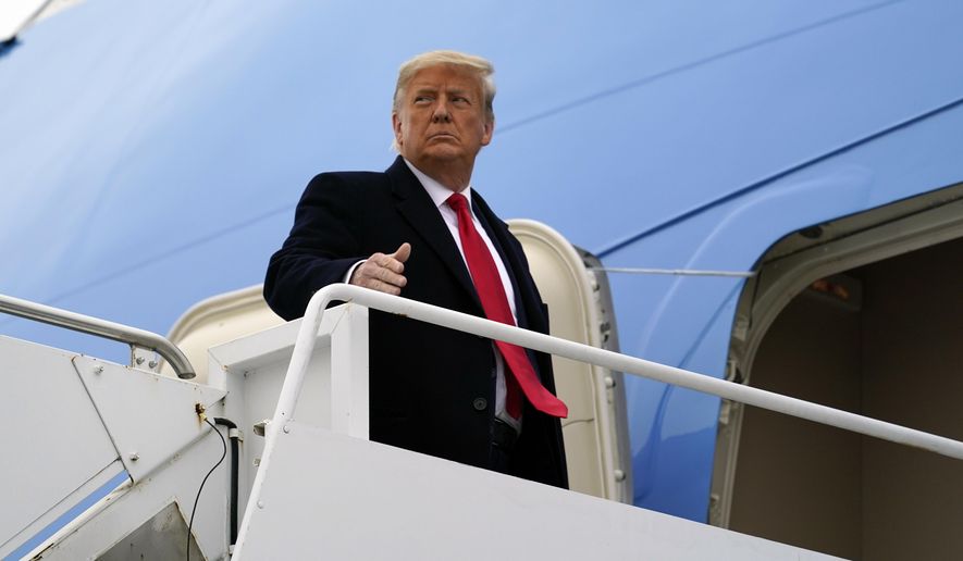 In this Tuesday, Jan. 12, 2021, photo, President Donald Trump gestures as he boards Air Force One upon arrival at Valley International Airport, in Harlingen, Texas. (AP Photo/Alex Brandon) ** FILE **