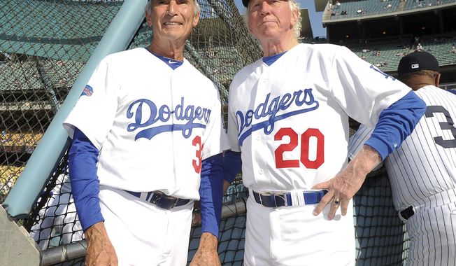 This June 8, 2013, photo shows Hall of Fame and former Los Angeles Dodgers pitcher Don Sutton, right, and Brooklyn Dodger pitcher Sandy Koufax, left, during the Old-Timers game prior to a baseball game between the Atlanta Braves and the Los Angeles Dodgers in Los Angeles. Sutton, a Hall of Fame pitcher who spent most of his career in a Los Angeles Dodgers&#x27; rotation that included Koufax and Don Drysdale, has died, Tuesday, Jan. 19, 2021. He was 75. (Keith Birmingham/The Orange County Register via AP, File)