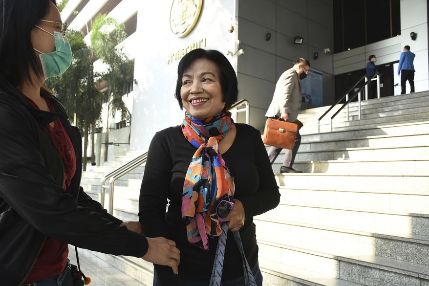 A woman identified only by her first name Anchan, right, talks to her friend as she arrives at the Bangkok Criminal Court in Bangkok, Thailand, Tuesday, Jan. 19, 2021. A court in Thailand on Tuesday sentenced the retired civil servant to a record 43.5 years in prison for insulting the monarchy by posting audio clips online of comments critical of the royal institution. (AP Photo)