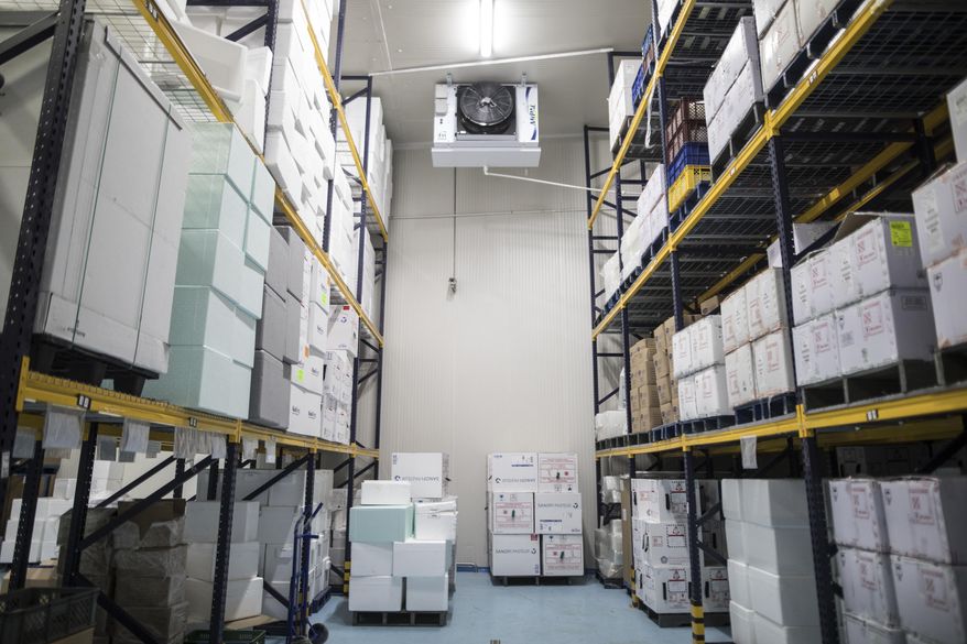 Boxes of vaccines, unrelated to COVID-19, are stored in a large refrigerator, during a media tour of the ministry warehouse where the vaccine for the new coronavirus will also be stored in freezers in Bogota, Colombia, Tuesday, Jan. 19, 2021. (AP Photo/Ivan Valencia)