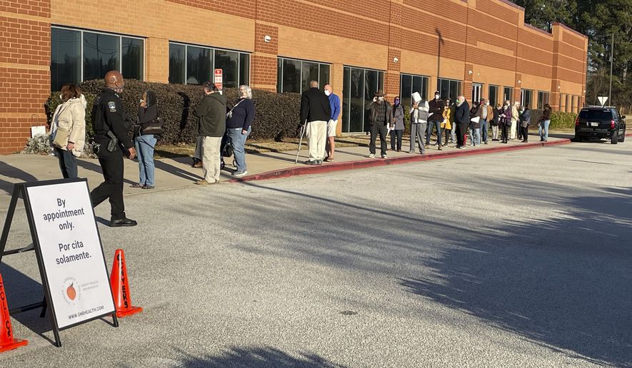 Residents wait in line to get Coronavirus vaccines at a public health department vaccination center, Tuesday, Jan. 19, 2021, in Conyers, Ga. (AP Photo/Ravi Nessman)