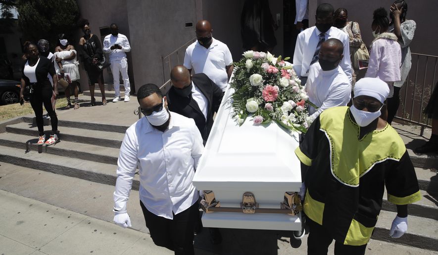 FILE - In this July 21, 2020, file photo, pall bearers carry a casket with the body of Lydia Nunez, who died from COVID-19, after a funeral service at the Metropolitan Baptist Church in Los Angeles. The U.S. death toll from the coronavirus has eclipsed 400,000 in the waning hours in office for President Donald Trump, whose handling of the crisis has been judged by public health experts to be a singular failure. (AP Photo/Marcio Jose Sanchez, File)