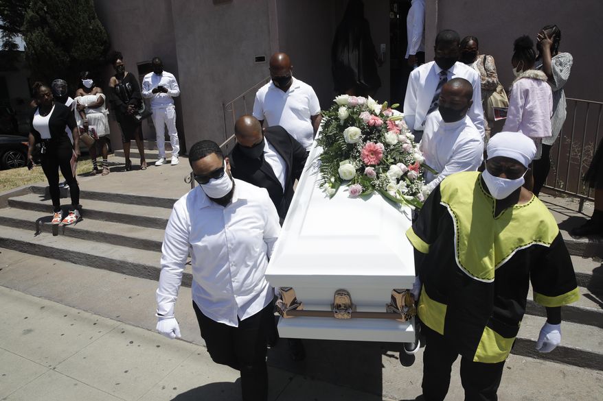 FILE - In this July 21, 2020, file photo, pall bearers carry a casket with the body of Lydia Nunez, who died from COVID-19, after a funeral service at the Metropolitan Baptist Church in Los Angeles. The U.S. death toll from the coronavirus has eclipsed 400,000 in the waning hours in office for President Donald Trump, whose handling of the crisis has been judged by public health experts to be a singular failure. (AP Photo/Marcio Jose Sanchez, File)