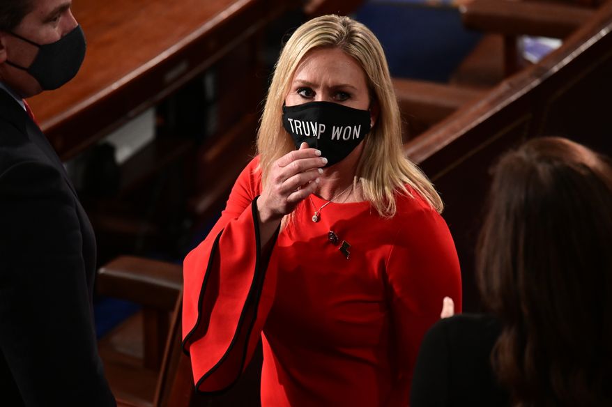 In this Sunday, Jan. 3, 2021, file photo, Rep. Marjorie Taylor Greene, R-Ga., wears a &quot;Trump Won&quot; face mask as she arrives on the floor of the House to take her oath of office on opening day of the 117th Congress at the U.S. Capitol in Washington. (Erin Scott/Pool Photo via AP, File)