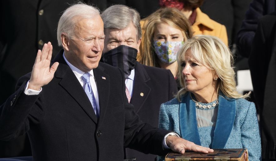 Joe Biden is sworn in as the 46th president of the United States by Chief Justice John Roberts as Jill Biden holds the Bible during the 59th Presidential Inauguration at the U.S. Capitol in Washington, Wednesday, Jan. 20, 2021. (AP Photo/Andrew Harnik)