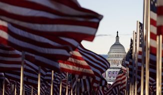 Flags line the National Mall towards the Capitol Building as events get underway for President-elect Joe Biden&#39;s inauguration ceremony, Wednesday, Jan. 20, 2021, in Washington. (AP Photo/Julio Cortez)