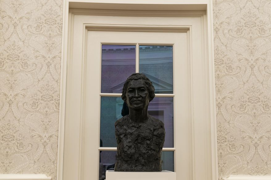 The Oval Office of the White House is newly redecorated for the first day of President Joe Biden&#39;s administration, Wednesday, Jan. 20, 2021, in Washington, including a bust of civil rights leader Rosa Parks. (AP Photo/Alex Brandon)