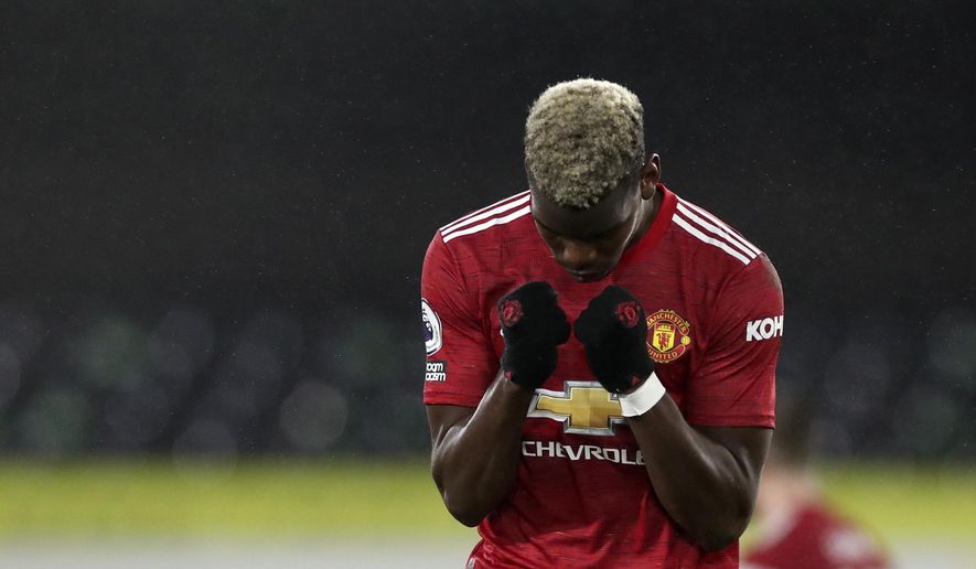 Manchester United&#39;s Paul Pogba celebrates at the end of the English Premier League soccer match between Fulham and Manchester United at the Craven Cottage stadium in London, Wednesday, Jan. 20, 2021. (Peter Cziborra/Pool via AP)