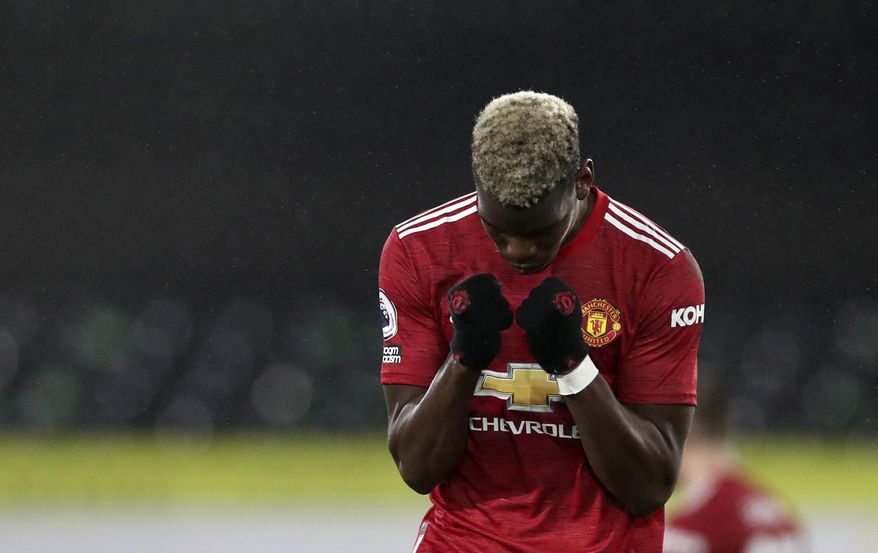 Manchester United&#x27;s Paul Pogba celebrates at the end of the English Premier League soccer match between Fulham and Manchester United at the Craven Cottage stadium in London, Wednesday, Jan. 20, 2021. (Peter Cziborra/Pool via AP)