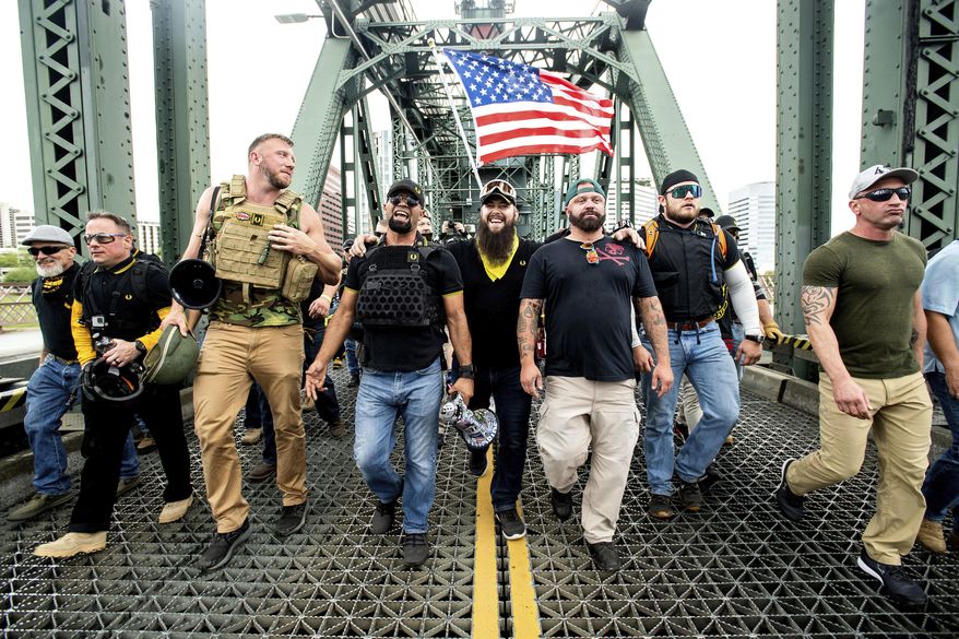 Members of the Proud Boys, including organizer Joe Biggs, third from right, march across the Hawthorne Bridge during an &#39;End Domestic Terrorism&#39; rally in Portland, Ore., on Saturday, Aug. 17, 2019.  (AP Photo/Noah Berger, file)