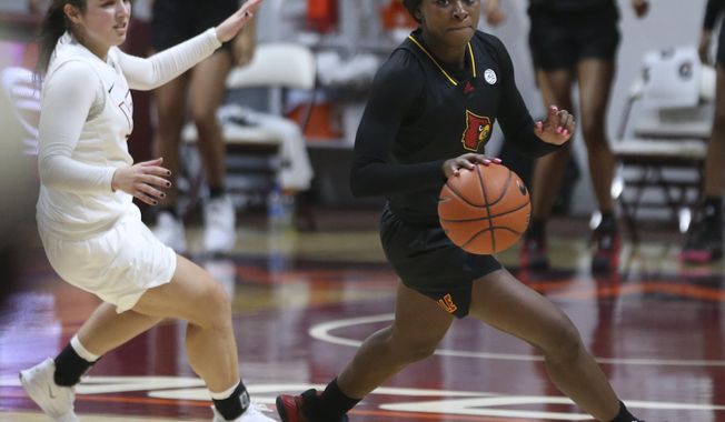 Louisville&#x27;s Dana Evans, right, escapes Virginia Tech&#x27;s Georgia Amoore after stealing the ball from her in the final moments of an NCAA college basketball game Thursday, Jan. 7, 2021, in Blacksburg, Va. (Matt Gentry/The Roanoke Times via AP, Pool)