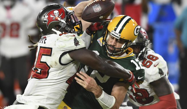 FILE - Tampa Bay Buccaneers inside linebacker Devin White (45) sacks Green Bay Packers quarterback Aaron Rodgers (12) during the second half of an NFL football game in Tampa, Fla., in this Sunday, Oct. 18, 2020, file photo. Rodgers had his worst game of the season in Green Bay’s 38-10 loss at Tampa Bay Back on Oct. 18, as he threw two game-changing interceptions and completed less than half his pass attempts. Rodgers gets a chance to make amends for that performance Sunday when the top-seeded Packers host the Bucs in the NFC championship game. (AP Photo/Jason Behnken, File)