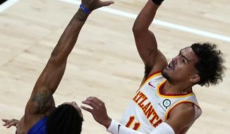 Atlanta Hawks guard Trae Young (11) shoots as Detroit Pistons guard Derrick Rose (25) defends during the first half of an NBA basketball game Wednesday, Jan. 20, 2021, in Atlanta. (AP Photo/John Bazemore)
