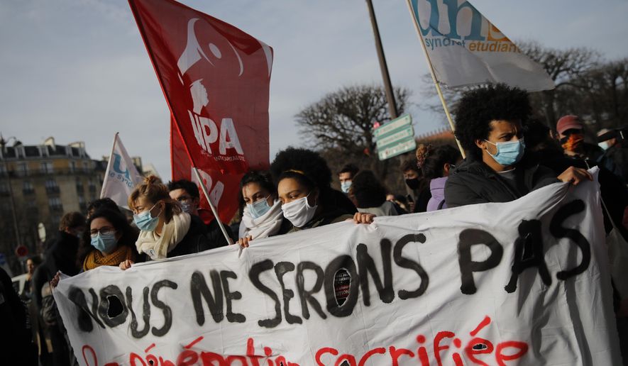 Students demonstrate with a banner reading &amp;quot;We will not be the the sacrificed generation&amp;quot; Wednesday, Jan. 20, 2021 in Paris. French university students protested Wednesday on Paris&#x27; Left Bank to demand to be allowed back to class, and to call attention to suicides and financial troubles among students cut off from friends, professors and job opportunities amid the pandemic. (AP Photo/Christophe Ena)