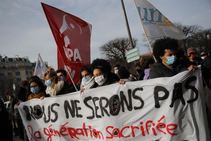 Students demonstrate with a banner reading &amp;quot;We will not be the the sacrificed generation&amp;quot; Wednesday, Jan. 20, 2021 in Paris. French university students protested Wednesday on Paris&#39; Left Bank to demand to be allowed back to class, and to call attention to suicides and financial troubles among students cut off from friends, professors and job opportunities amid the pandemic. (AP Photo/Christophe Ena)
