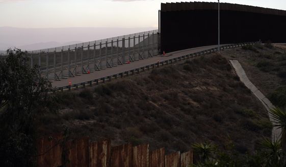 An incomplete secondary wall stands alongside the previous version near where the border separating Tijuana, Mexico, and San Diego meets the Pacific Ocean Tuesday, Jan. 19, 2021, in Tijuana, Mexico. In the days before Joe Biden became president, construction crews worked quickly to finish Donald Trump&#39;s wall at an iconic cross-border park overlooking the Pacific Ocean that then-first lady Pat Nixon inaugurated in 1971 as symbol of international friendship. (AP Photo/Gregory Bull)