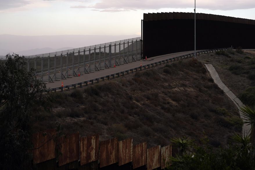 An incomplete secondary wall stands alongside the previous version near where the border separating Tijuana, Mexico, and San Diego meets the Pacific Ocean Tuesday, Jan. 19, 2021, in Tijuana, Mexico. In the days before Joe Biden became president, construction crews worked quickly to finish Donald Trump&#x27;s wall at an iconic cross-border park overlooking the Pacific Ocean that then-first lady Pat Nixon inaugurated in 1971 as symbol of international friendship. (AP Photo/Gregory Bull)