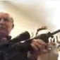 In this screen grab taken from a Zoom meeting provided by the Grand Traverse County Board of Commissioners, Grand Traverse County Commissioner Ron Clous holds a rifle at his home during a county commissioner meeting Wednesday, Jan. 20, 2021, in Michigan. Clous displayed the rifle during the online meeting in response to a citizen&#39;s comments about a far-right extremist group, drawing backlash from some local residents. (Grand Traverse County Board of Commissioners via AP)