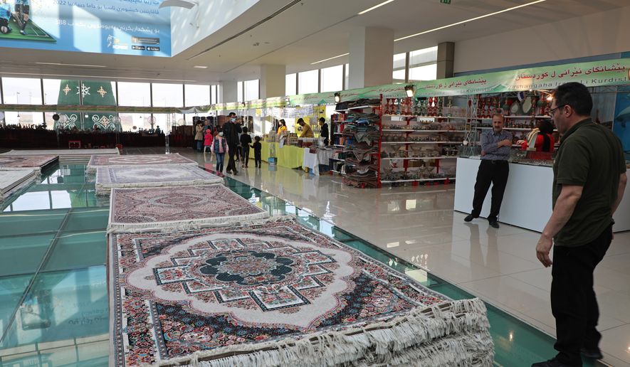 Piles of plush Iranian- made carpets line the floors of a shopping center in northern Iraq, hosting traders from neighbouring Iran, in the city of Dohuk, in the Kurdish-run northern region of Iraq, Wednesday, Jan. 20, 2021. At least 24 businesses from 15 Iranian cities offer hope that the spangle of their ornate handicrafts might offer a lifeline out of poverty for Iranians whose country&#39;s economy is in tatters amid crippling sanctions. (AP Photo/Rashid Yahya)