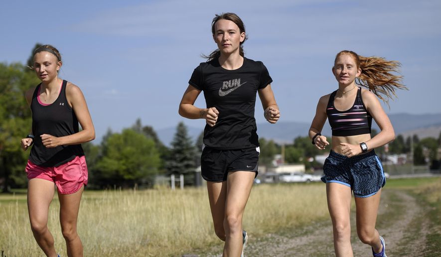FILE - In this Aug. 15, 2019, file photo, is University of Montana cross country runner Juniper Eastwood, center, warming up with her teammates at Campbell Park in Missoula, Mont. Transgender kids would be banned from playing on school sports teams for the gender with which they identify under a GOP-backed bill that advanced Thursday, Jan. 21, 2021, in Montana. The proposed ban is personal for people like Eastwood, a transgender woman and former member of the University of Montana&#x27;s track and field and cross-country running teams. She said the legislation &amp;quot;would make it impossible for other young Montanans like me to participate in sports as who they are.&amp;quot; (Rachel Leathe/Bozeman Daily Chronicle via AP, file)