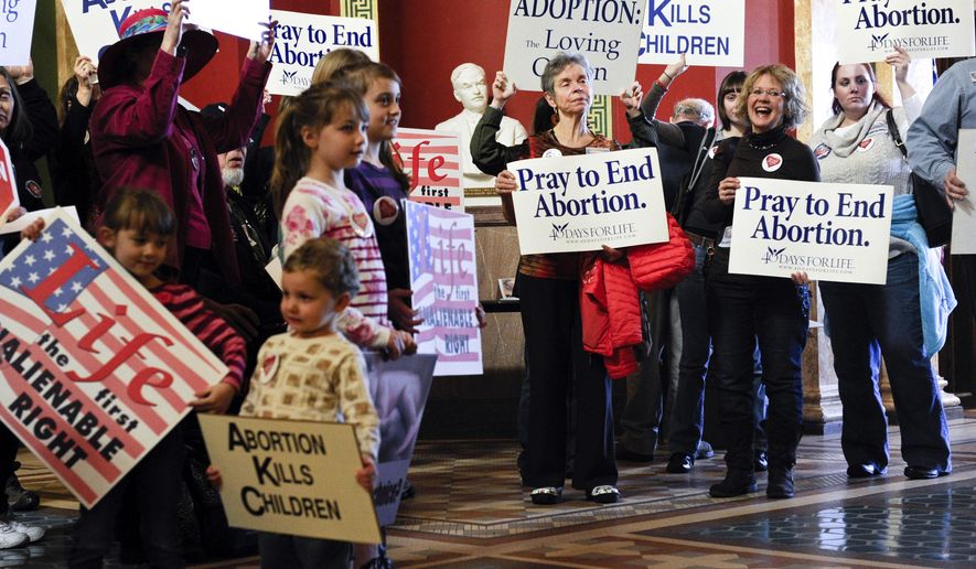 FILE - In this Feb. 11, 2015, file photo, protesters fill the Capitol rotunda in Helena, Mont., during a rally to show support in an attempt to change the Montana Constitution to define life as beginning at conception. Republican lawmakers in Montana are pushing a series of bills that would limit abortion access and remove gun restrictions, hoping to capitalize on GOP control following the November election. Montana has a Republican governor for the first time in 16 years, opening the door to pass into law bills previously vetoed by Democratic governors. (Thom Bridge/Independent Record via AP, File)