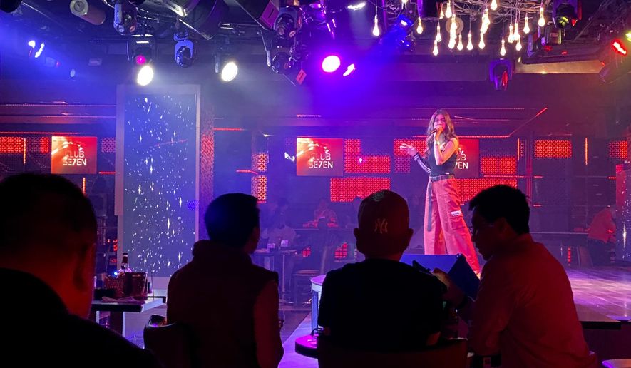 A singer performs at a nightclub in Dubai, United Arab Emirates, Nov. 5, 2020. On Thursday, Jan 21, 2021, Dubai’s tourism authorities announced an immediate halt to all live music and shows at hotels and restaurants as coronavirus cases surged to unseen heights over recent weeks. The UAE also ordered the suspension of all non-urgent surgeries to deal with an influx of new COVID-19 patients. (AP Photo/Kamran Jebreili)