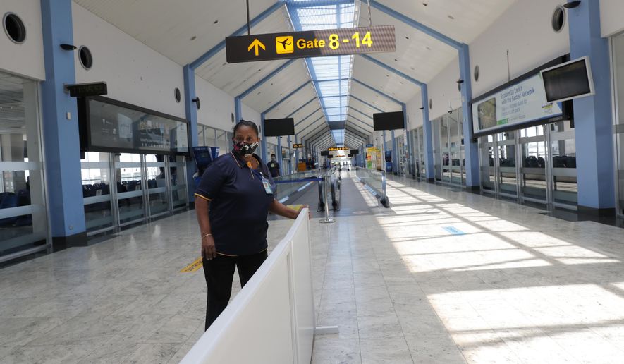 A Sri Lankan airport worker arranges a partition inside a terminal at the Katunayake International Airport in Colombo, Sri Lanka, Wednesday, Jan. 20, 2021. Sri Lanka&#x27;s tourism minister said that the airports in the country will be reopened for tourists according to health guidelines from Jan.21. (AP Photo/Eranga Jayawardena)