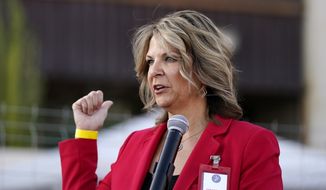 In this Nov. 18, 2020, file photo, Kelli Ward, chair of the Arizona Republican Party, holds a press conference in Phoenix. Ms. Ward won reelection as chairwoman of the state party on Jan. 23, 2021 after being endorsed by former President Donald Trump. (AP Photo/Ross D. Franklin, File)  **FILE**