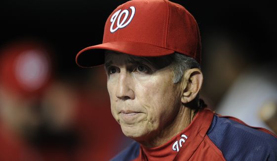 In this Aug. 7, 2013, file photo, Washington Nationals manager Davey Johnson watches from the dugout during the sixth inning of the team&#x27;s baseball game against the Atlanta Braves in Washington. Johnson is in a Florida hospital with COVID-19, according to former New York Mets spokesman Jay Horwitz. Horwitz said he spoke with Johnson briefly on Friday. Johnson, 77, was a four-time All-Star second baseman and managed the Mets to their last World Series title in 1986. (AP Photo/Nick Wass, File) **FILE**