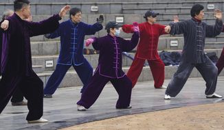Residents practice Taiji at a park in Wuhan in central China&#39;s Hubei Province on Saturday, Jan. 23, 2021. A year after it was locked down to contain the spread of coronavirus, the central Chinese city of Wuhan has largely returned to normal, even as China continues to battle outbreaks elsewhere in the country. (AP Photo/Ng Han Guan)