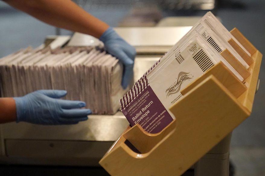FILE - In this Nov. 1, 2020, file photo, envelopes containing ballots are shown at a San Francisco Department of Elections at a voting center in San Francisco. California election officials announced Friday, Jan. 22, 2021, that 99.4% of more than 15 million mail-in ballots were verified and counted in the November election, a rejection rate notably lower than the March primary even though more than twice as many people voted. (AP Photo/Jeff Chiu, File)