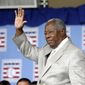 Hall of Famer Hank Aaron waves to the crowd during Baseball Hall of Fame induction ceremonies in Cooperstown, N.Y., in this Sunday, July 28, 2013, file photo. Hank Aaron, who endured racist threats with stoic dignity during his pursuit of Babe Ruth but went on to break the career home run record in the pre-steroids era, died early Friday, Jan. 22, 2021. He was 86. The Atlanta Braves said Aaron died peacefully in his sleep. No cause of death was given. (AP Photo/Mike Groll, File) **FILE**