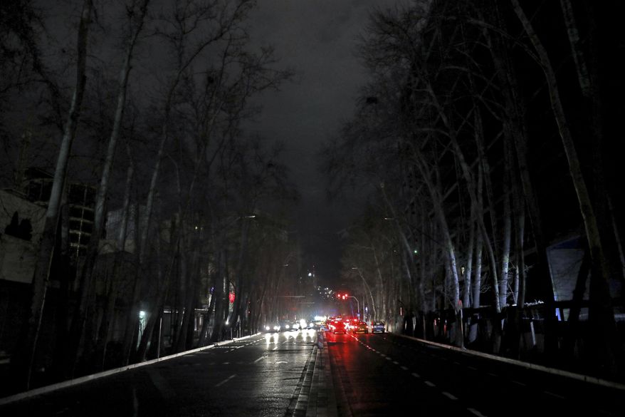 Cars drive on an unlit street during a blackout in Tehran, Iran, Wednesday, Jan 20, 2021. Speculation has gripped social media in Iran that Bitcoin is to blame for a series of recent power blackouts across the country. The government launched a major crackdown on Bitcoin processing centers which use immense amounts of electricity and are a huge burden on the power grid. (AP Photo/Ebrahim Noroozi)
