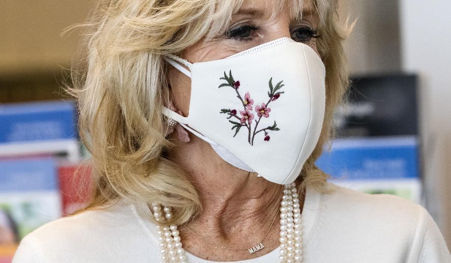 First lady Jill Biden&#x27;s necklace says &amp;quot;Mama,&amp;quot; as she takes a tour of Whitman-Walker Health, Friday, Jan. 22, 2021, in Washington. (AP Photo/Jacquelyn Martin, Pool)