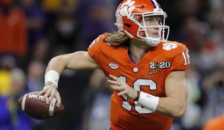 FILE - Clemson quarterback Trevor Lawrence passes against LSU during the second half of a NCAA College Football Playoff national championship game in New Orleans, in this Monday, Jan. 13, 2020, file photo.  Ohio State quarterback Justin Fields was among 98 juniors granted eligibility by the NFL into the draft, while national championship-winning QBs Mac Jones from Alabama and Trevor Lawrence from Clemson were among another 30 players eligible after completing their degrees and deciding not to play more in college. (AP Photo/Gerald Herbert, File)