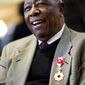 Hank Aaron smiles after being presented with the Order of the Rising Sun, Gold Rays with Rosette by the Consul General of Japan at his official residence Thursday, Jan. 14, 2016, in Atlanta. Japan has honored the former home run king with one of its highest awards, bestowing the Order of the Rising Sun for bringing young people and countries together through baseball. (AP Photo/David Goldman)