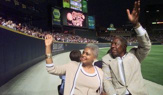 Major League Baseball&#39;s all-time career home run record holder Hank Aaron and his wife Billye take a lap in a golf cart around Turner Field in Atlanta, Thursday, April, 8, 1999, after a ceremony to mark the 25th anniversary of his breaking Babe Ruth&#39;s record of 714 home runs on April 8, 1974. (AP Photo/John Bazemore)